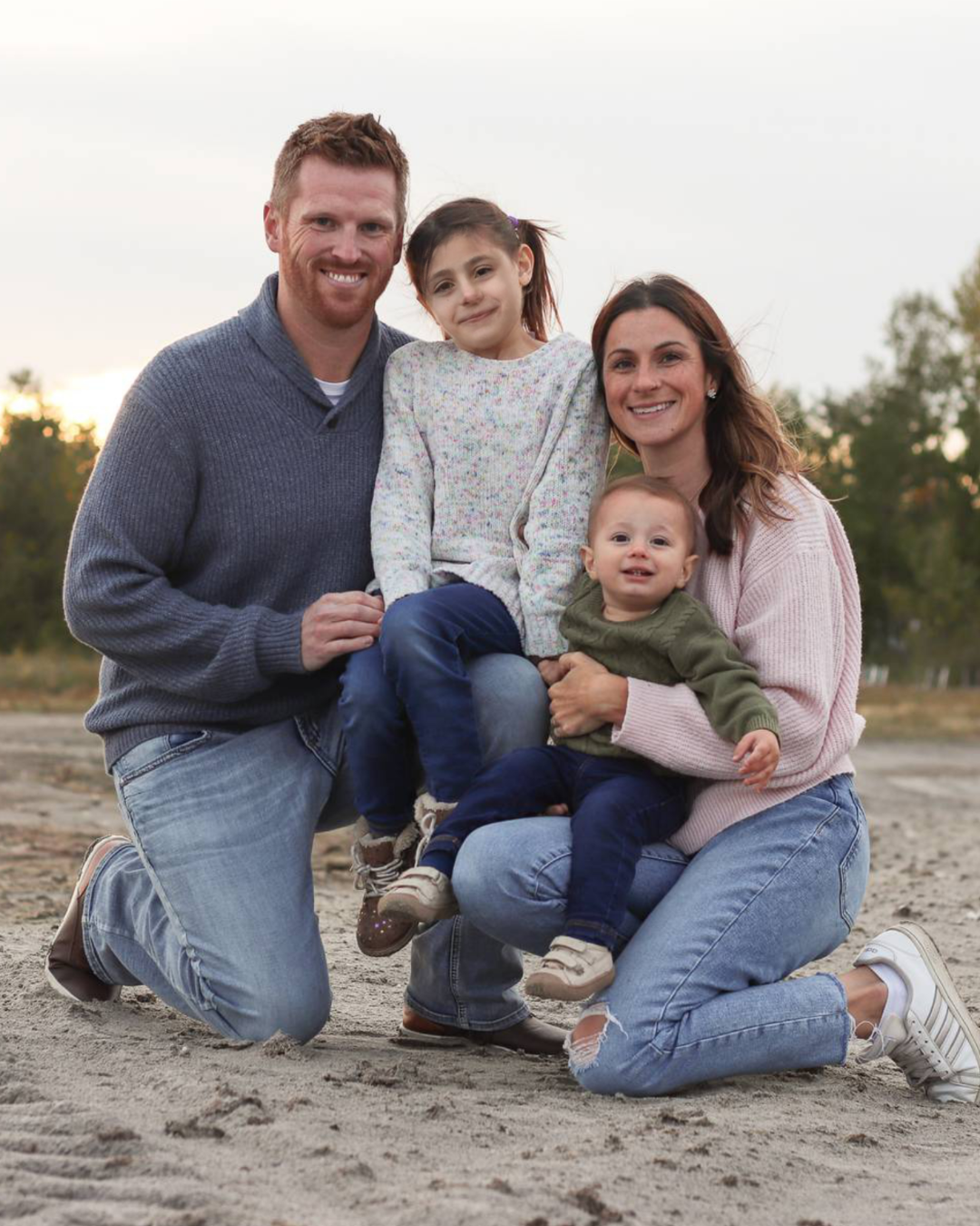 Dusty Myshrall with his wife Reagan and their two children outdoors