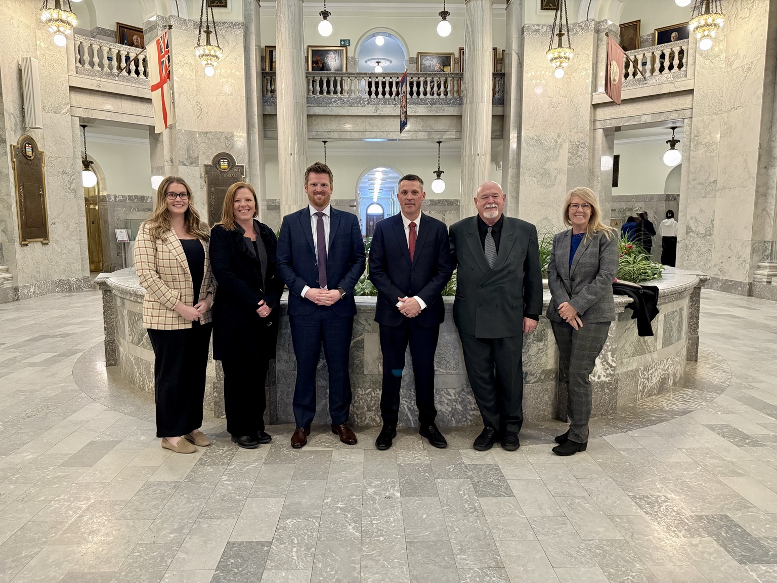 Dusty Myshrall with community representatives inside the Alberta Legislature